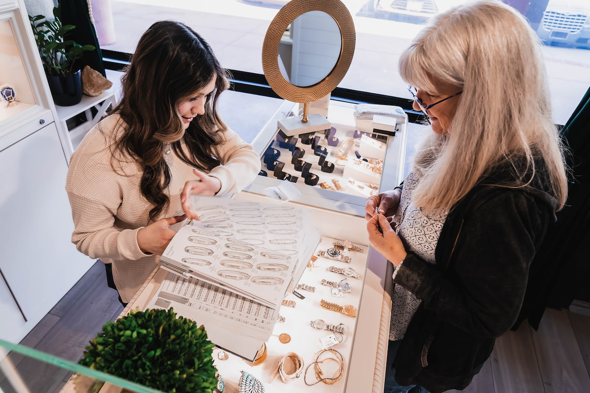 A jewelry consultant helping out a woman with jewelry design 