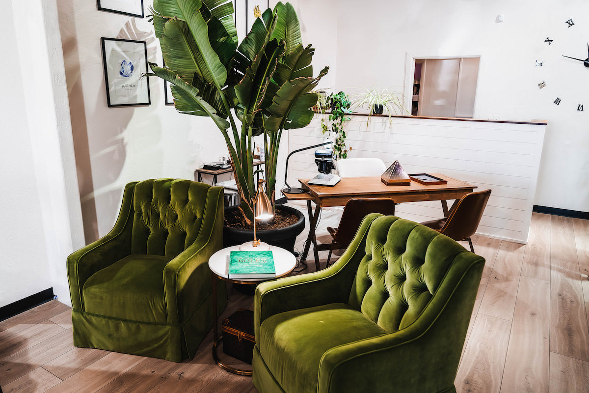 Some green suede comfy chairs within the retail location of Andrew Z Diamonds and Fine Jewelry  