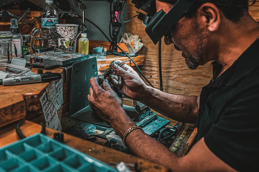 Master Jeweler repairing a bracelet at his work bench