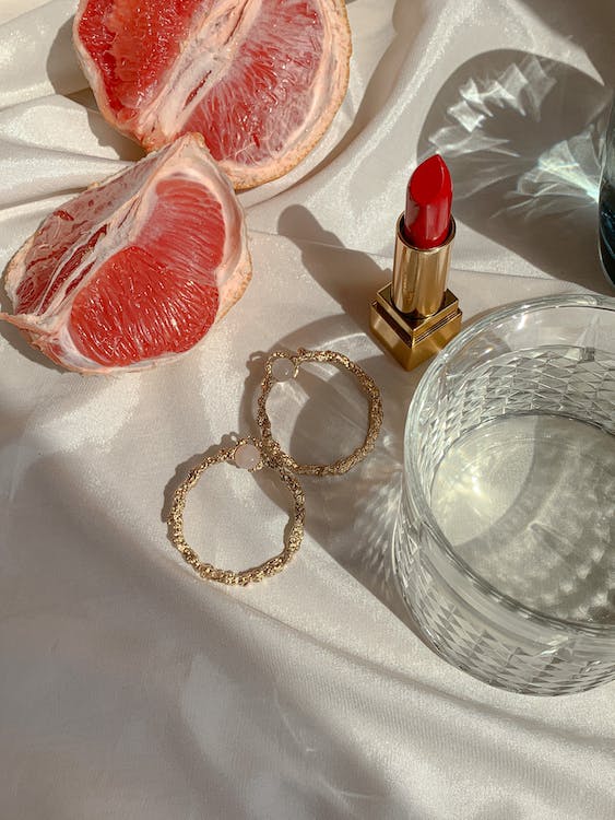 Vintage earrings with grapefruit and lipstick 
